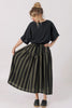 Front view of model wearing Ayana Top in Black and Jessie Stripe Skirt in Mud in front of white background