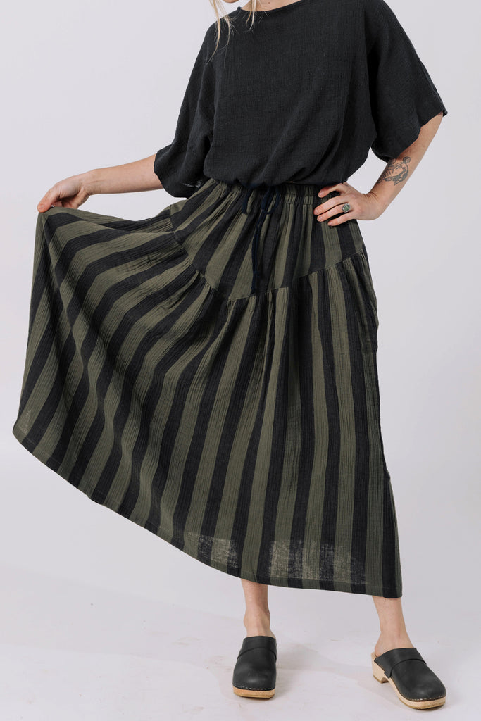 Front view of model wearing Ayana Top in Black and Jessie Stripe Skirt in Mud in front of white background