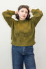 Anya Checkerboard Sweater in Fennel paired with denim jeans on model in front of white background