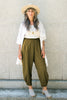 Cadence Pant in Fennel paired with Workshirt in Natural on model standing in front of stone background