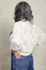 Back view of model wearing Anya Checkerboard Sweater in Biscuit on white background
