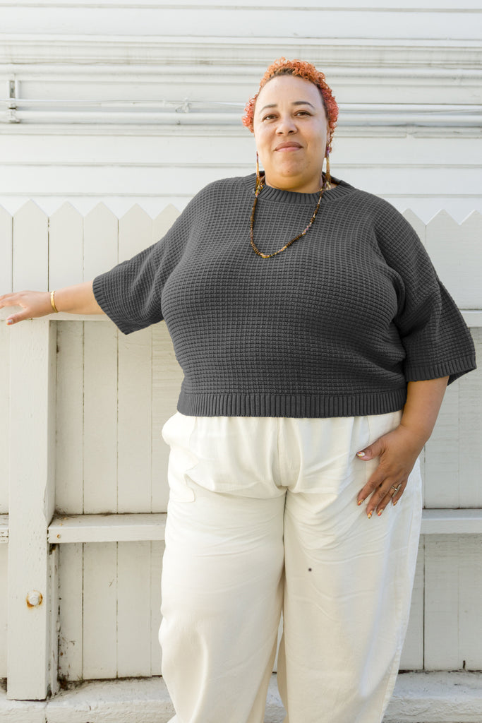 Front view of Cody Waffle Tea in Charcoal paired with Cadence Pants in Natural on model in front of white building