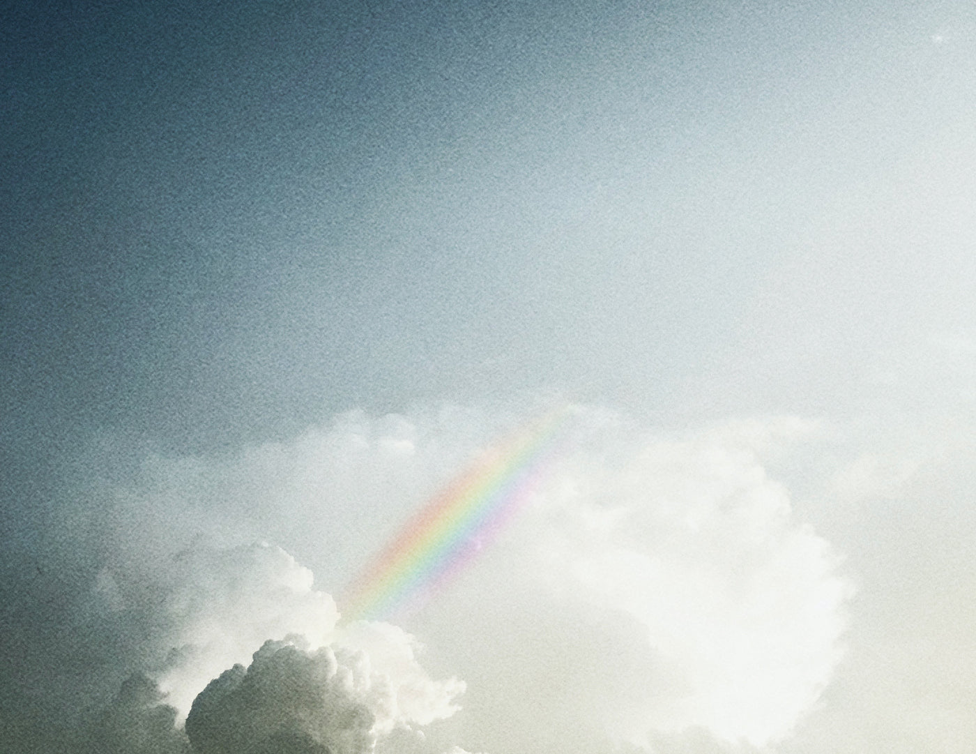 image of clouds and rainbow