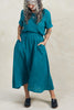 Model wearing Noa Top and Fawn Skirt both in Ocean/Black Stripe, standing ith hands in skirt pockets in front of white background