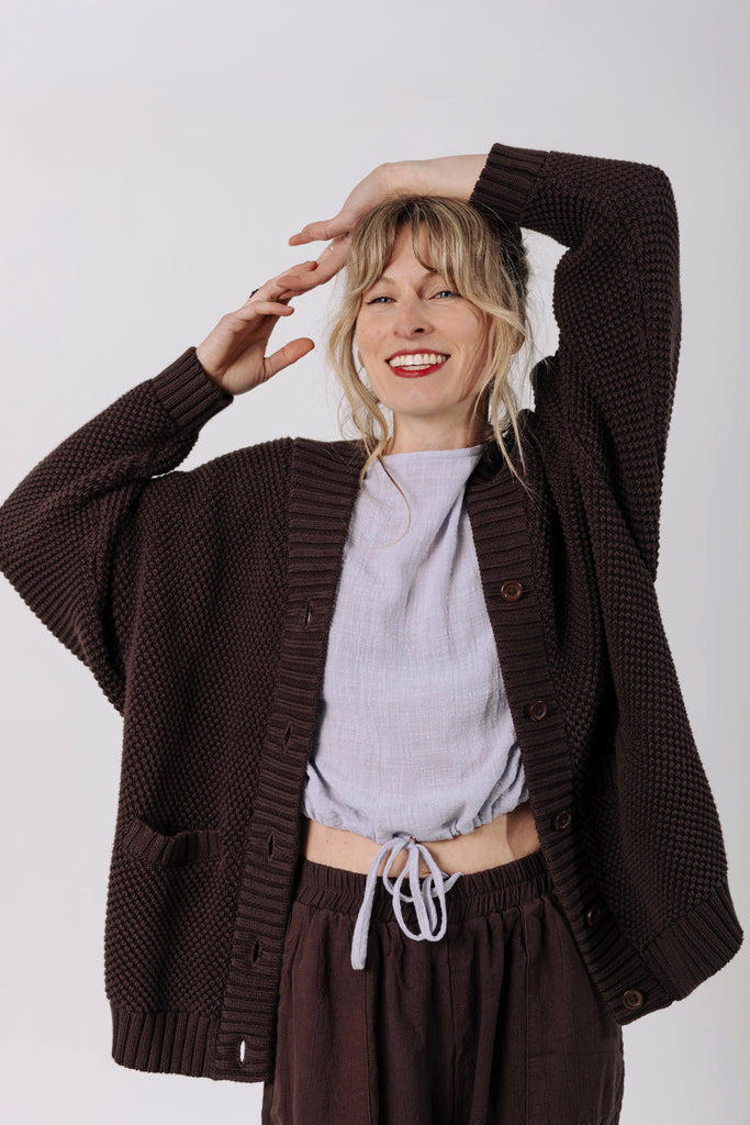 Front view of model wearing Frankie Cardigan in Chocolate, Ayana Top in Mist, and Atlas Pant in Chocolate in front of white background