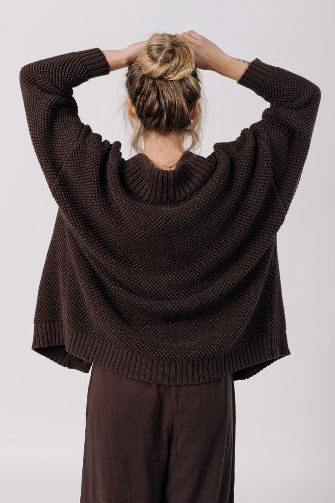 Back view of model wearing Frankie Cardigan in Chocolate and Atlas Pant in Chocolate in front of white background