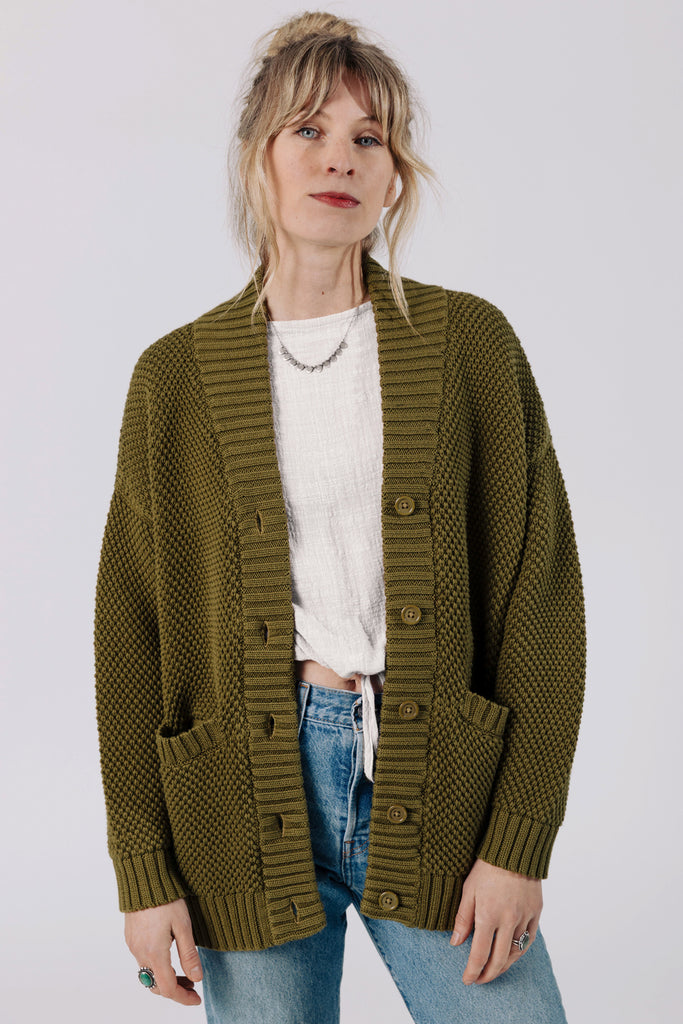 Front view of model wearing Frankie Cardigan in Fennel, Ayana Top in White, and light wash jeans, in front of white background