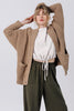 Front view of model wearing Frankie Cardigan in Tan , Ayana Top in White, and Atlas Pant in Mud in front of white background