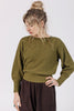 Front view of model wearing Ivy Sweater in Fennel and Atlas Pant in Chocolate, standing with one hand on hip in front of white background