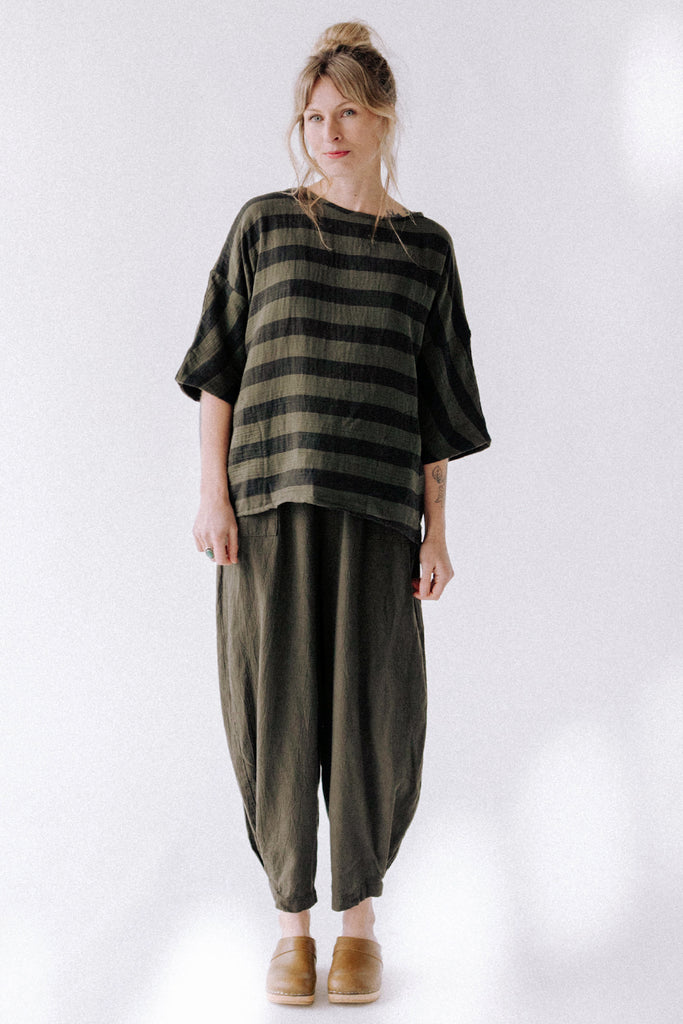 Front view of model wearing Izzy Top in Mud Stripe and Cadence Pant in Mud in front of white background
