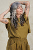 Model wearing Jones Top and Larkin Pant both in Fennel in front of white background