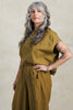 Model wearing Jones Top and Larkin Pant both in Fennel in front of white background