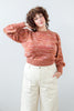 Model wearing Roni Sweater in Rust Melange and Painter Pant in Natural standing in front of white background
