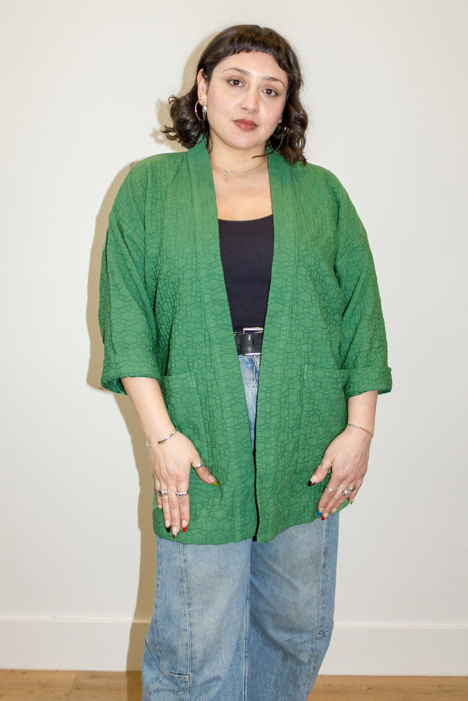 Jules Cardigan in Fern on model in front of white wall
