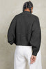 Back view of Lino Sweater in Charcoal on model standing in front of white background