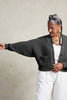 Lino Cardigan in Charcoal on model with arm raised, in front of white background