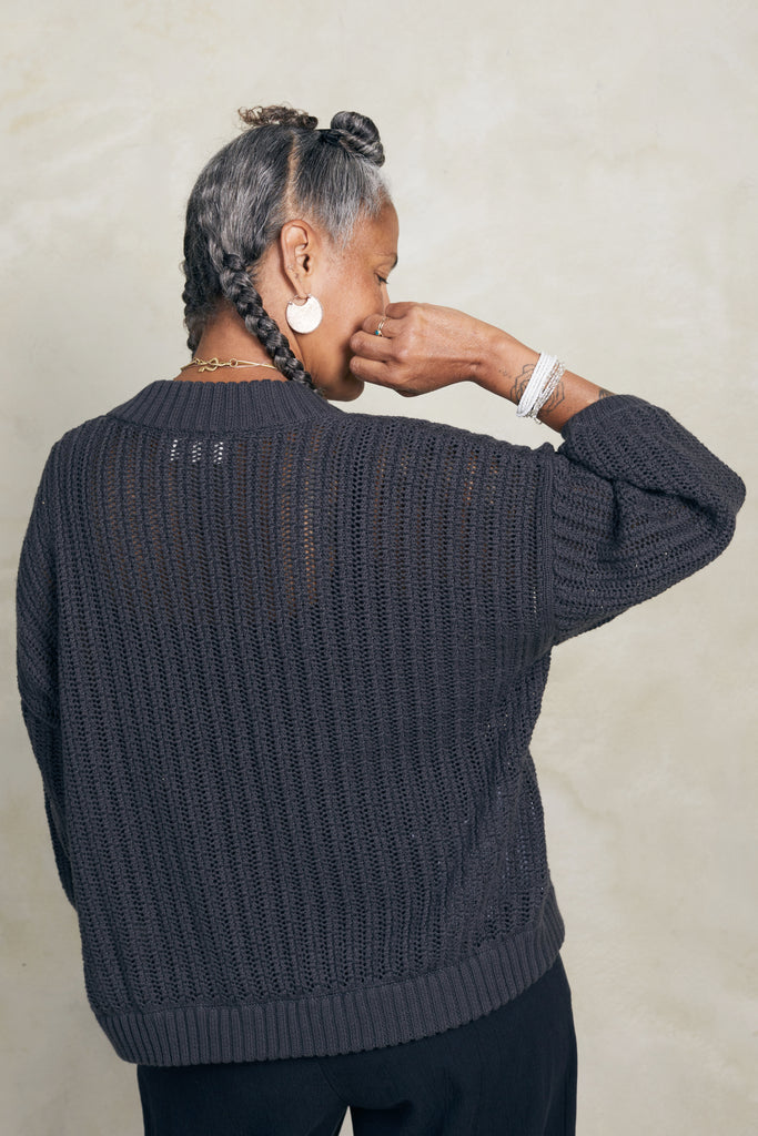 Back view of Maeva Cardigan in Charcoal on model in front of white background