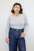 Maisie Long Sleeve Top in Oyster paired with denim jeans on model in front of white wall