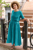Noa Stripe Top in Ocean, paired with Fawn Stripe Skirt in Ocean, on model standing in front of stairs.