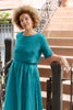 Noa Stripe Top in Ocean, paired with Fawn Stripe Skirt in Ocean, on model standing in front of stairs.