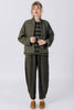 Front view of model wearing Oona Cardigan, Izzy Stripe Top, and Cadence Pant, all in Mud, standing in front of white background