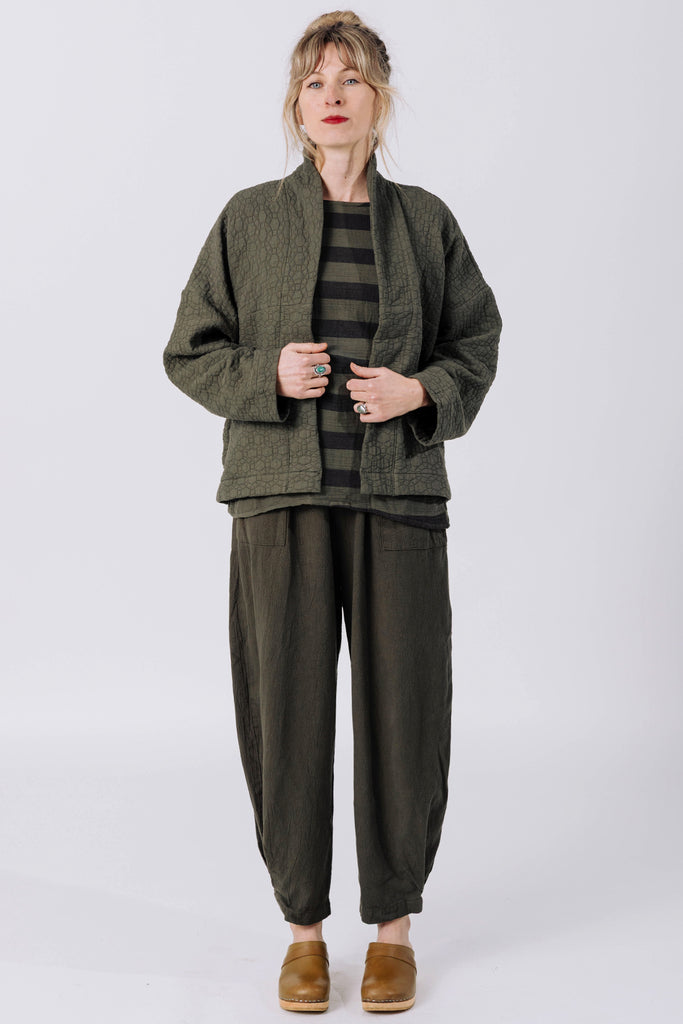 Front view of model wearing Oona Cardigan, Izzy Stripe Top, and Cadence Pant, all in Mud, standing in front of white background