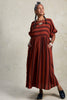 Perry Stripe Dress in Brick on model with hands in pockets in front of white background