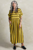 Model wearing Perry Stripe Dress in Dijon, standing with one hand in a pocket, in front of white background