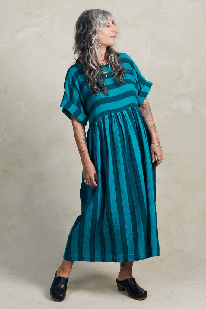 Perry Stripe Dress in Ocean on model standing in front of white background