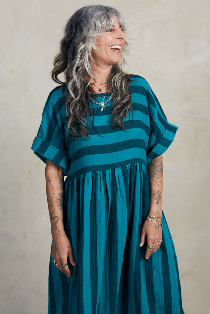 Perry Stripe Dress in Ocean on model standing in front of white background