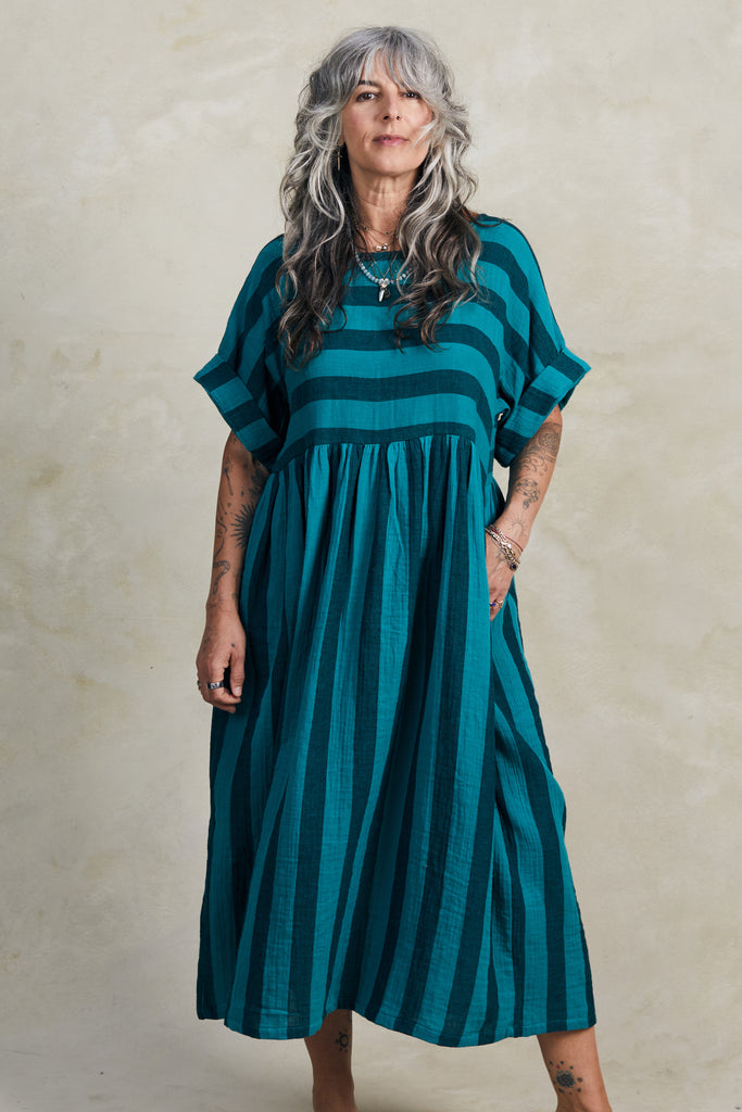 Perry Stripe Dress in Ocean on model standing in front of white background