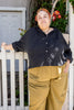 Model wearing Cropped Poet Blouse in Black and Cadence Pants in Dijon, leaning against white fence