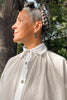 Close up view of model in Cropped Poet Blouse in White, with tree in the background