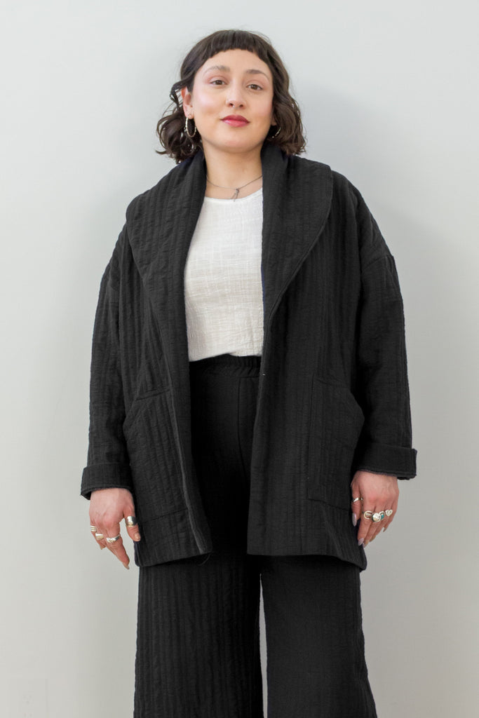 Front view of Sadie Coat in Black on model in front of white wall