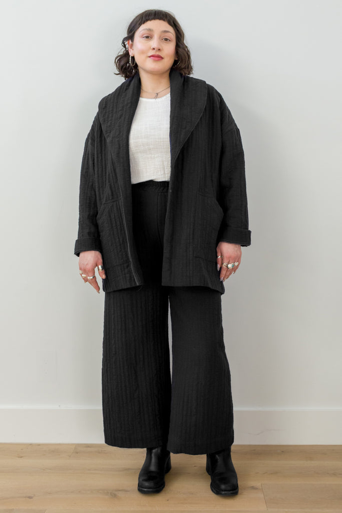 Front view of model wearing Sadie Coat in Black, Ayana Top in White, and Dover Pant in Black, in front of white background