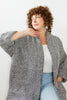Model wearing Sloane Coat in Black/White in front of white wall