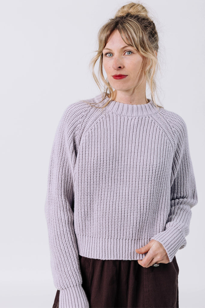 Front view of model wearing Sonnie Sweater in Mist and Atlas Pant in Chocolate in front of white background
