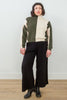 Front view of model wearing Sybil Vertical Stripe Sweater in Olive/Cream and Wide Leg Pant in Black, standing in front of white background