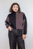 Front view of model wearing Sybil Vertical Stripe Sweater in Peppercorn/Black and black jeans, standing with one hand in pocket in front of white background