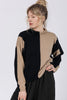 Front view of model wearing Sybil Vertical Stripe Sweater in Black/Tan and Atlas Pant in Black, standing with one hand on hip in front of white background