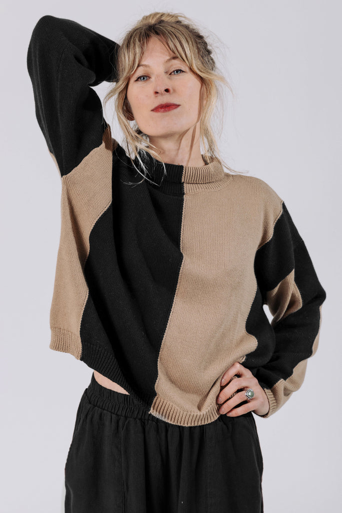 Front view of model wearing Sybil Vertical Stripe Sweater in Black/Tan and Atlas Pant in Black, in front of white background