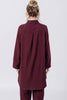 Back view of model wearing Workshirt in Burgundy and Cadence Pant in Burgundy, standing in front of white background