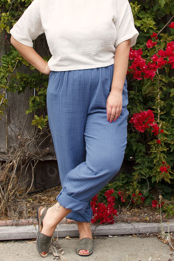 light blue elastic waist pants on model in white top