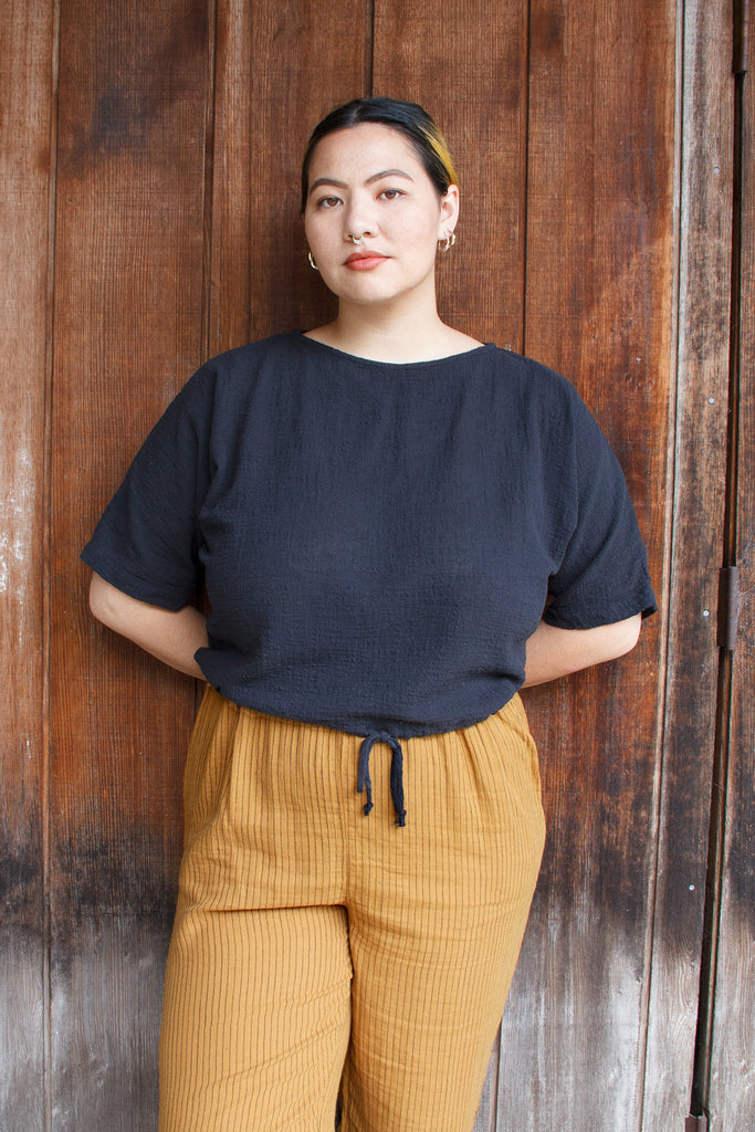 Black drop sleeve top on model
