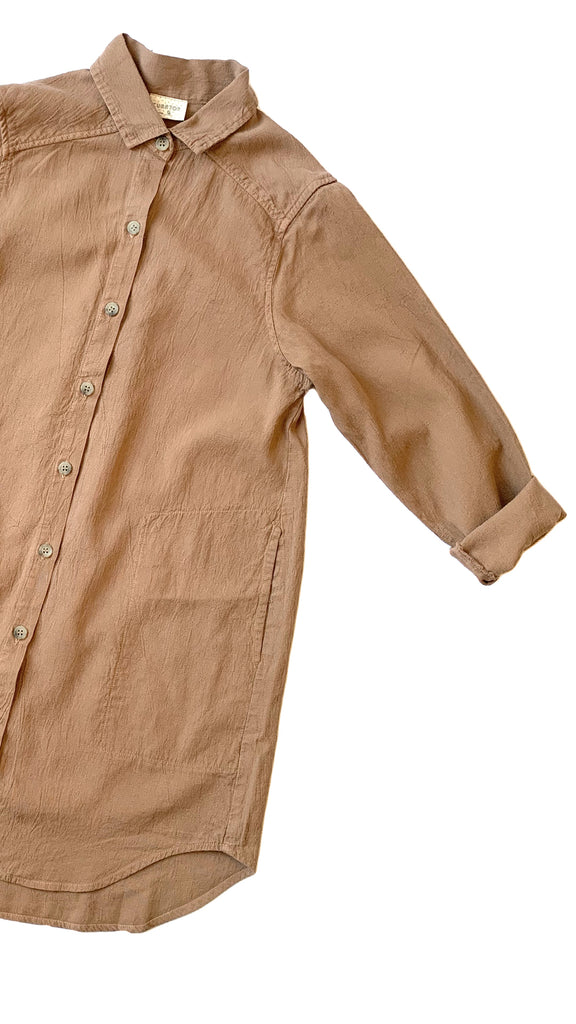 close up of button up collared shirt in camel tan